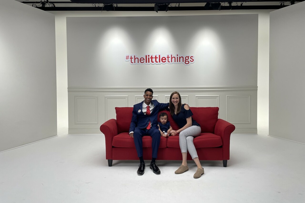 Al Jones and his family on a red couch.