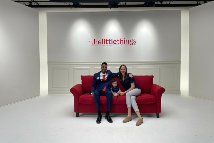 Al Jones and his family on a red couch.