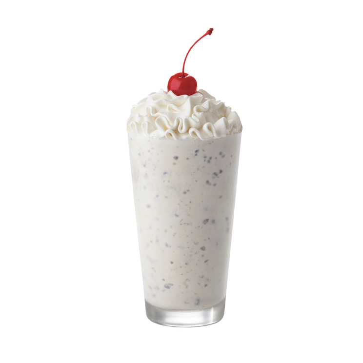 Cookies & Cream Milkshake topped with whipped cream and a maraschino cherry.