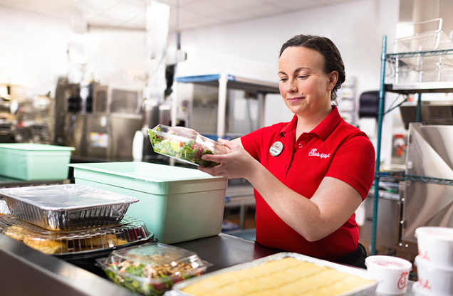 A team member packs food for donation.