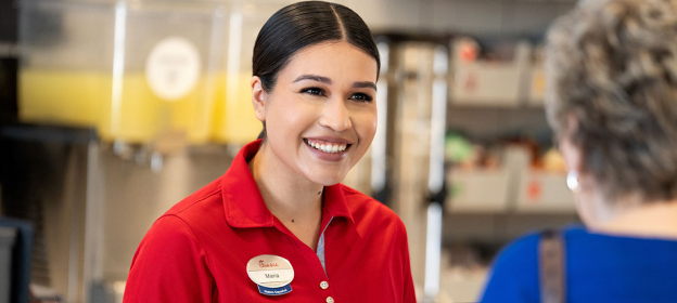 A Team Member smiling at a customer