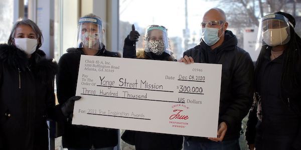 A group of people from Yonge Street Mission holding an oversized check.