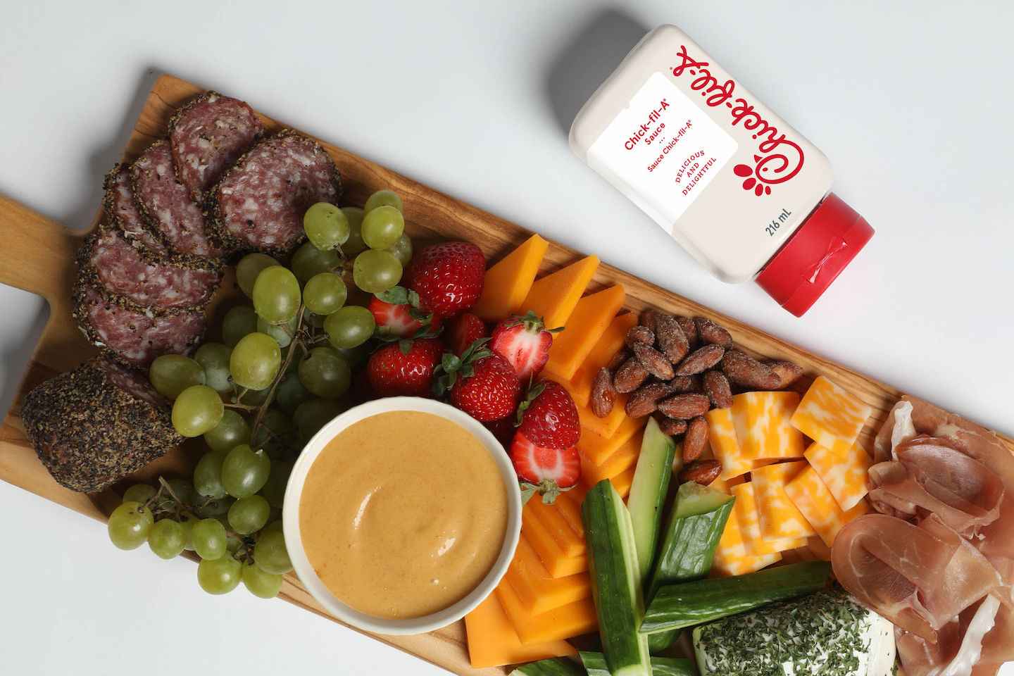  Charcuterie Board with Chick-fil-A sauce, cheeses, meats, fruits, and vegetables.