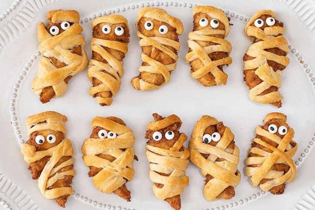 Chicken Strips wrapped in dough to look like mummies.