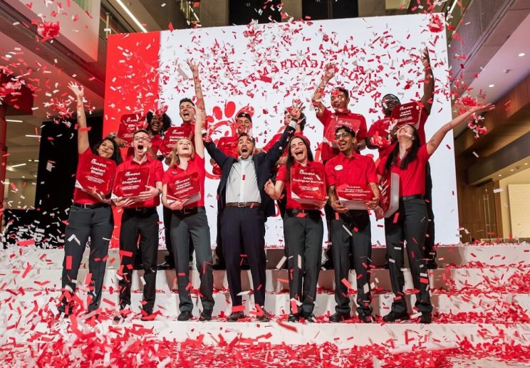 Chick-fil-A Remarkable Futures Scholars on stage celebrating as confetti comes down.