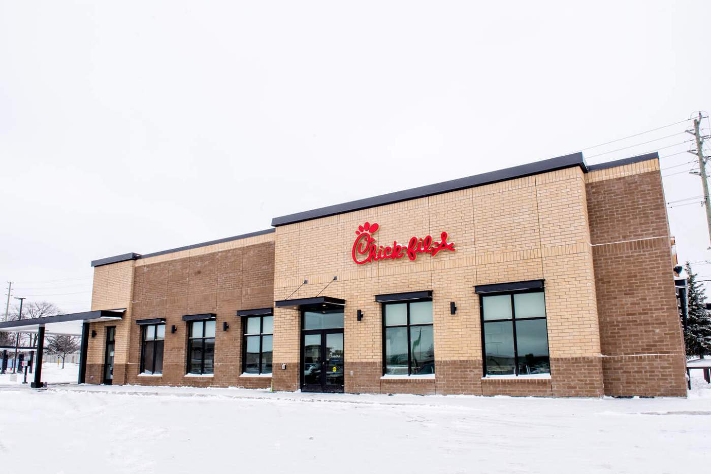 Chick-fil-A restaurant in a snowy setting with a red logo above the entrance.
