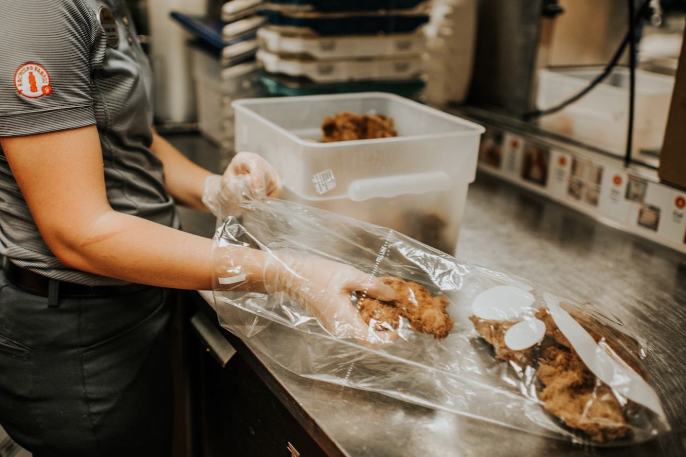 A Chick-fil-A team member packs chicken for Shared Table donation.
