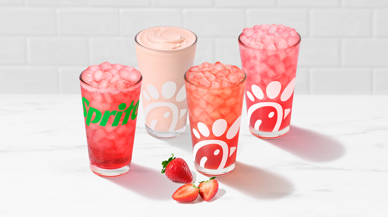 Strawberry Hibiscus & Sprite®, Frosted Lemonade, Sunjoy® and Lemonade with strawberry slices on a white counter