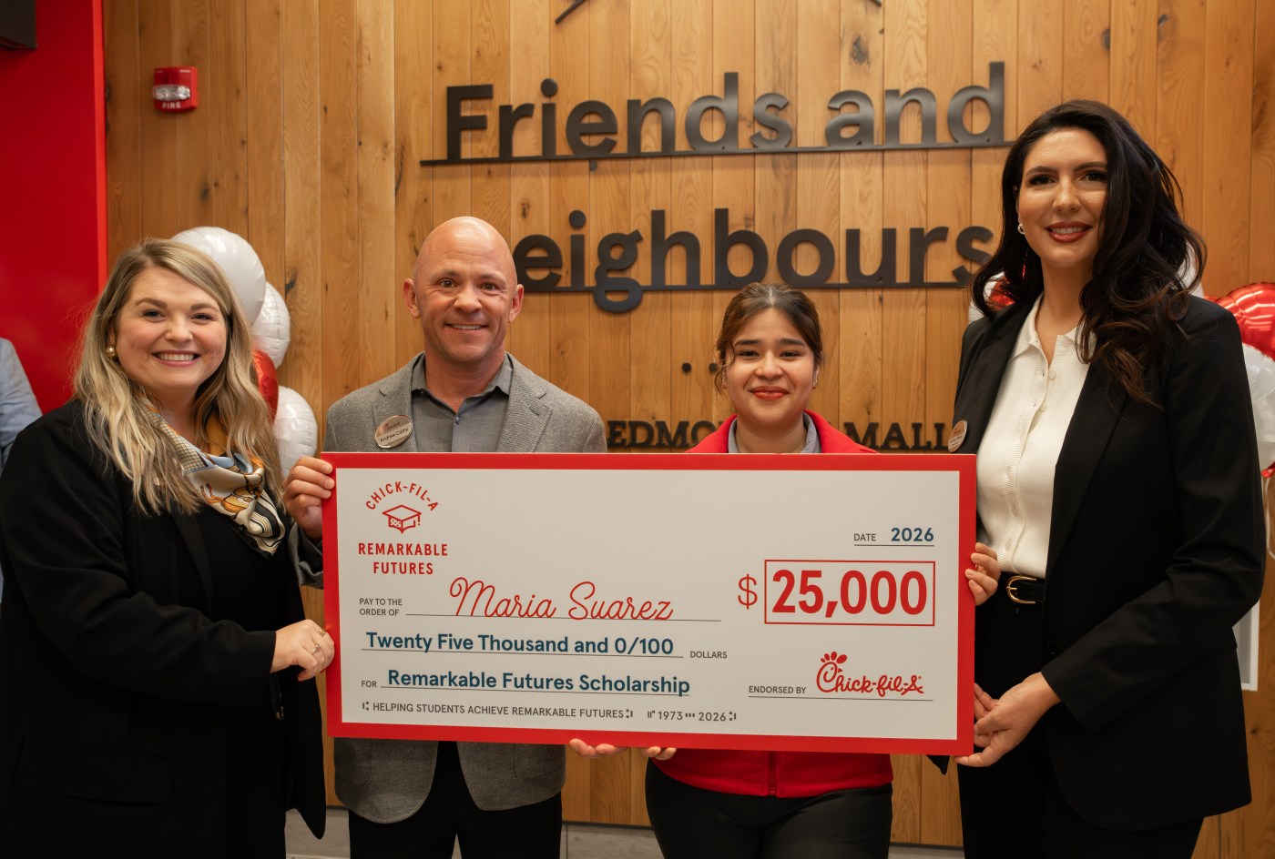 Remarkable Futures Scholarship recipient Maria Suarez holding a check.