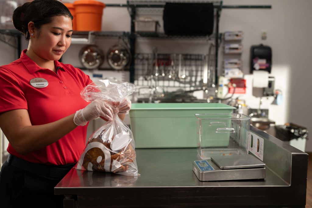 Chick-fil-A Team Member prepping food for Shared Table.